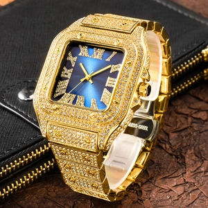 Detail of gold iced out square watch with blue dial and stainless steel case back