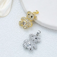 Macro shot of gold and silver bear pendants with cubic zirconia inlay and hanging loops