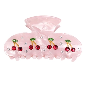 Pink marble acrylic hair claw clip with red cherry rhinestone decor on white background