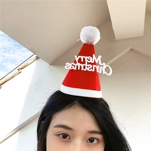 Close-up of a festive mini Santa hat headband with Merry Christmas text on a model