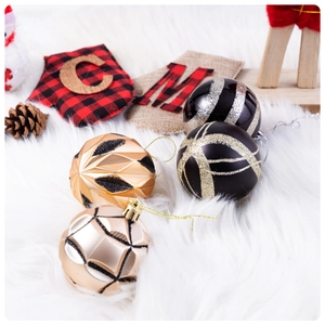 Detailed view of assorted Christmas ornaments with stockings and baubles on white fur