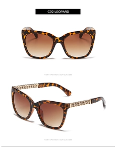 Detail of leopard print cat eye sunglasses with gradient lenses and metal chain temples