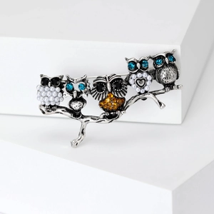Fashion owl brooch with colorful rhinestones and pearls on a silver branch