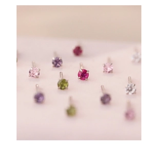 Detailed close-up of S999 silver stud earrings with colorful cubic zirconia stones