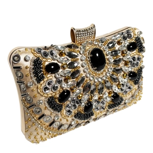 Elegant evening clutch bag featuring luxurious beads and black crystals on a gold frame
