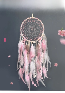 Pink and white dream catcher featuring lace ribbons and soft hanging feathers