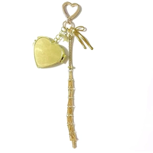 Golden heart locket keychain with star butterfly charms and long tassel chain