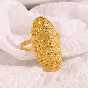 Close-up of 18K gold plated ring featuring a hammered oval texture and minimalist style