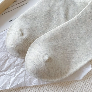 Detail shot of breathable grey knit sock toe stitching with soft flecked yarn texture
