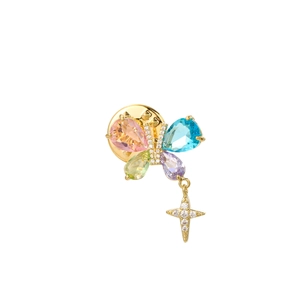 Detail of butterfly brooch with colorful gemstones, micro-paved crystals and star pendant