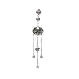 Macro detail of vintage silver Chinese padlock pendant with carved fish and lotus symbols