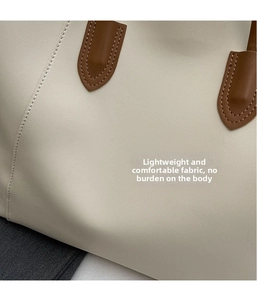 Close-up of premium leather texture and precise stitching on a minimalist tote bag