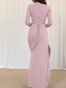 Detail of slim fit long sleeve dress with backless crisscross strap design in dusty pink