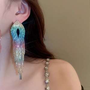 Close-up of long colorful gradient rhinestone tassel earrings worn by a fashion model