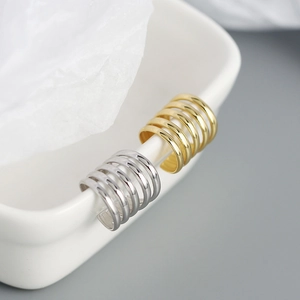 Macro view of minimalist 5-layer gold and silver ear cuffs in s925 sterling silver