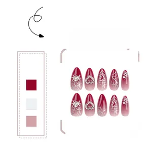 Detailed view of red gradient press-on nails with silver spider and heart charms