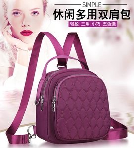 Detail of purple nylon backpack featuring quilted diamond pattern and adjustable straps