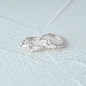 Detail of S925 silver hoop earrings featuring pear and rectangular cubic zirconia
