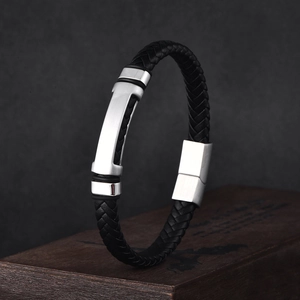 Close-up of black braided leather men's bracelet with a silver stainless steel magnetic clasp