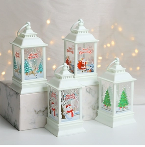 Close-up of four white LED Christmas lanterns with Merry Christmas prints on marble blocks