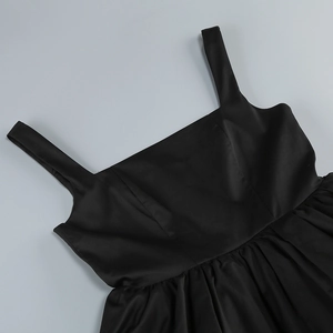 Detail of square neckline and wide straps on a vintage black party dress with pleated waist