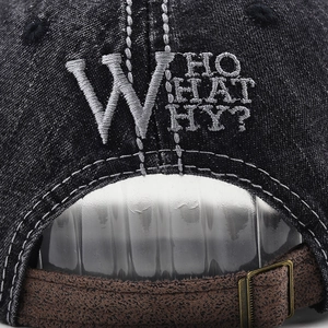 Detail of adjustable brown strap and Who What Why embroidery on washed denim cap