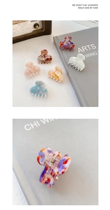 Detail view of mini acetate hair claws with various marble patterns and metal spring