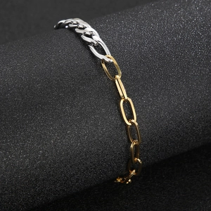 Detail view of two-tone stainless steel curb and paperclip chain bracelet on a stand