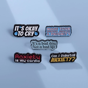 Five mental health enamel pins set with encouraging English quotes on a blue background
