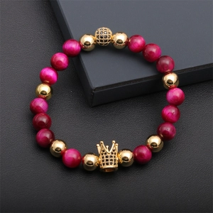 Detail of beaded bracelet with magenta tiger eye stones and micro-paved gold crown bead