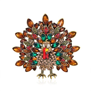 Macro view of a golden peacock brooch with colorful crystals and intricate detailing