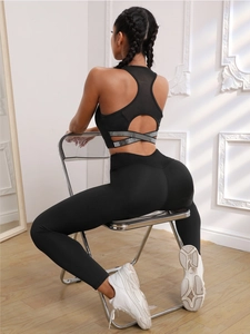 Detail of black high-waist yoga set with cutout back design and silver reflective stripes