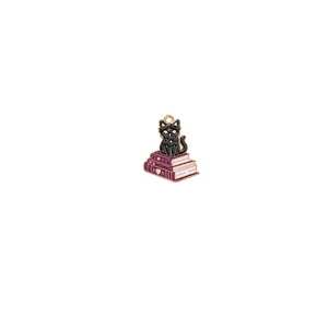 Detail view of black cat on stacked books charm with gold metal and enamel finish
