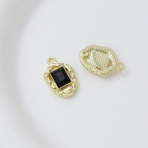Detailed macro view of gold-plated alloy pendant with black rectangular zircon inlay