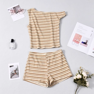 Flat lay of brown striped knit two-piece set with chic fashion accessories