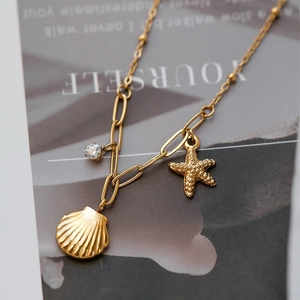 Gold ocean necklace with starfish shell charms and zircon on an oval link chain