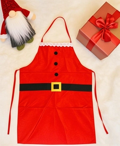 Detail of red Santa apron with black buttons and gold buckle on plush white background