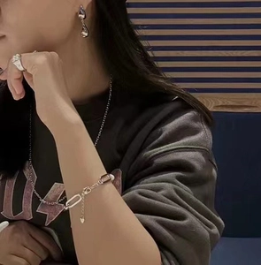 Detail shot of silver water-drop earrings and matching jewelry on an elegant model