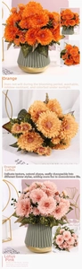 Detail of silk gerbera daisies in orange and pink tones within vintage gold-rimmed vases
