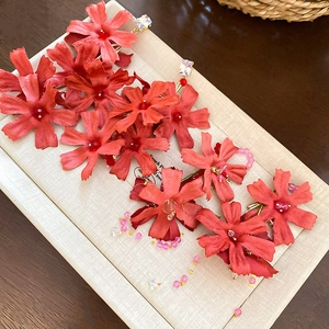 Elegant floral tassel earrings with red fabric petals and crystals on display box