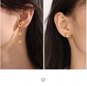 Detail view of gold geometric coffee bean earrings in drop and stud styles on a model