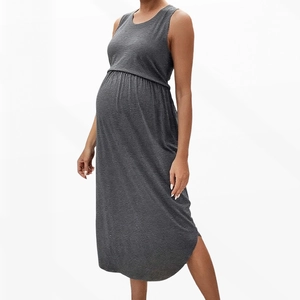 Detail view of the side slit and high-waisted cut on this sleeveless maternity dress