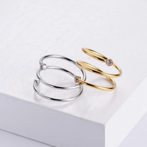 Macro view of spiral wrap rings in gold and silver finish with sparkling zircon stones