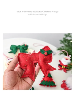 Detail of a handmade red felt bow ornament with gold polka dots for Christmas tree decor