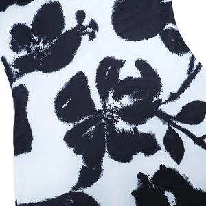 Detail of artistic black and white ink floral print on sleek fitted dress fabric