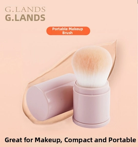 Macro view of portable makeup brush with soft gradient bristles and a light pink cap