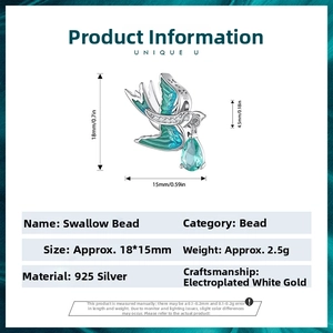 Detail of 925 sterling silver swallow charm with teal enamel and blue drop zircon