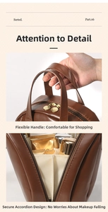 Detail of brown PU leather makeup bag with dual gold zippers and interior organizers