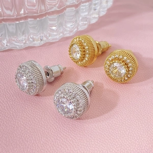 Detailed view of round cubic zirconia flower earrings in gold and silver finish