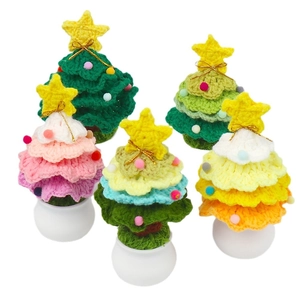 Set of five colorful crochet Christmas trees in small white pots with gold stars